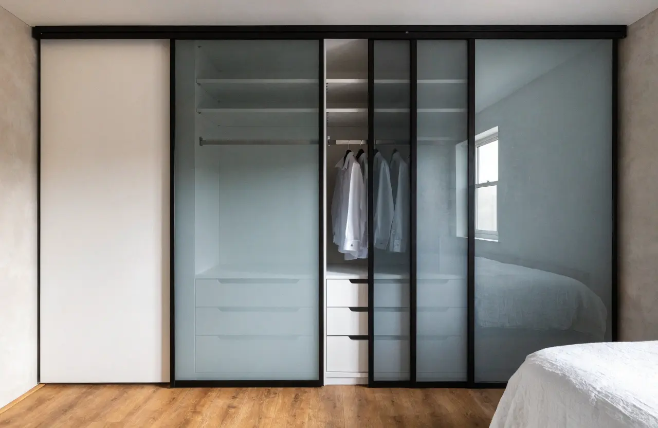 Custom sliding wardrobe doors with frosted glass and slim black aluminium frames
