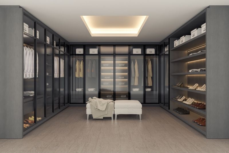 spacious walk in wardrobe storage for shoes and clothes with crystal door