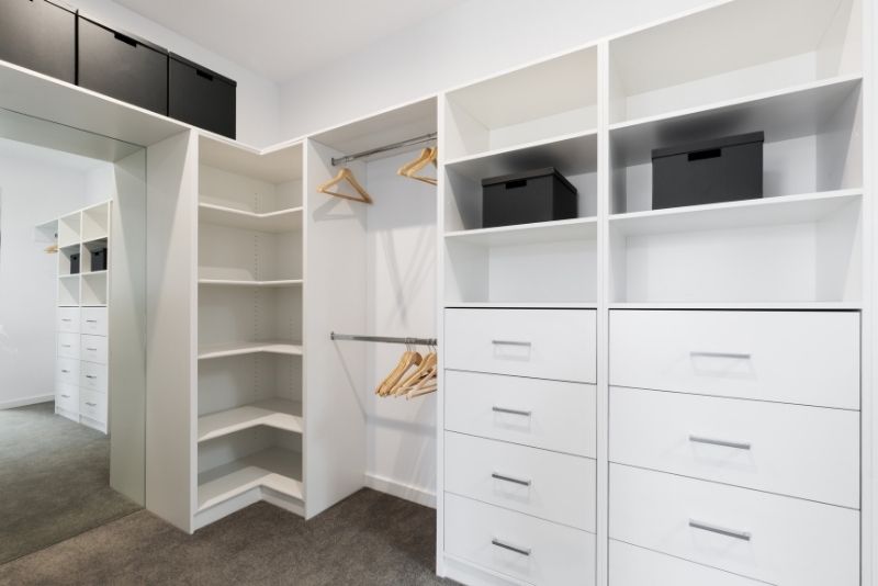 white coloured built in wardrobe area with mirror on the side