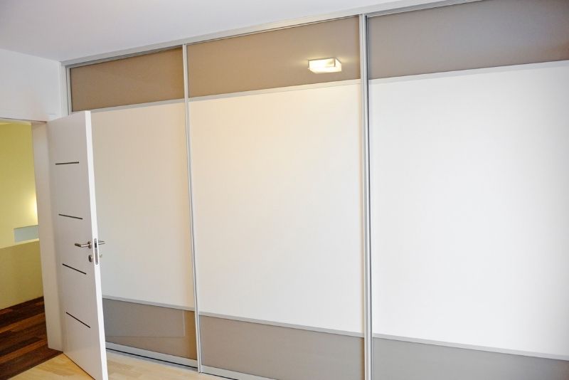 sliding door wardrobe behind the opened door