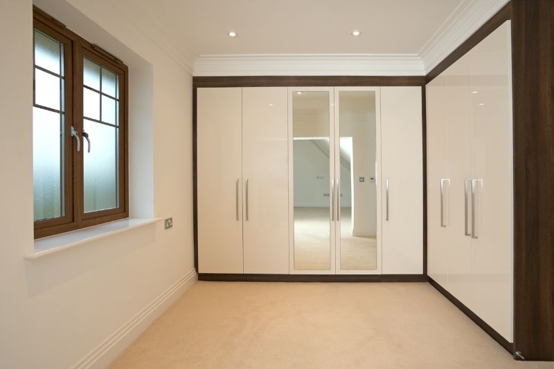 L-shaped built-in wardrobe with hinged doors